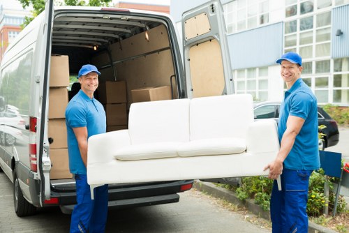 Removal team loading household items into a moving truck