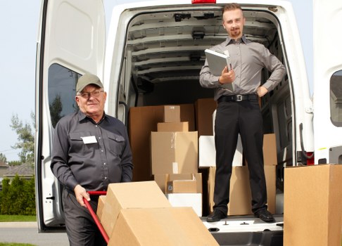 Local office movers handling workplace furniture carefully