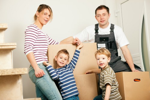 Removal crew carrying furniture from a Watford home with local access considerations