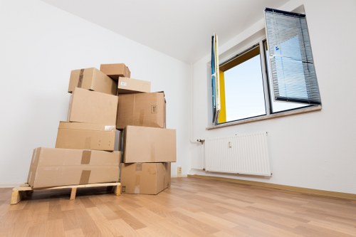 Moving boxes and furniture prepared for a Watford home removal