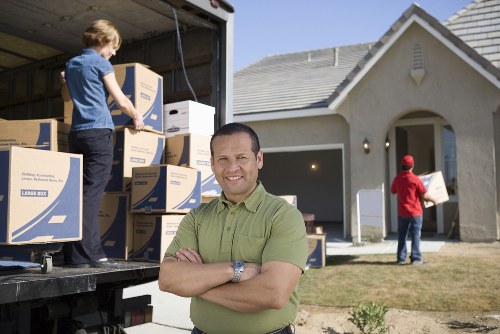 Loading furniture and boxes into a moving truck in Watford
