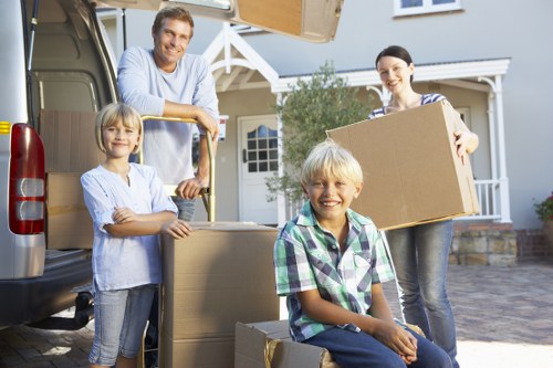 Professional movers carrying furniture from a home in Watford